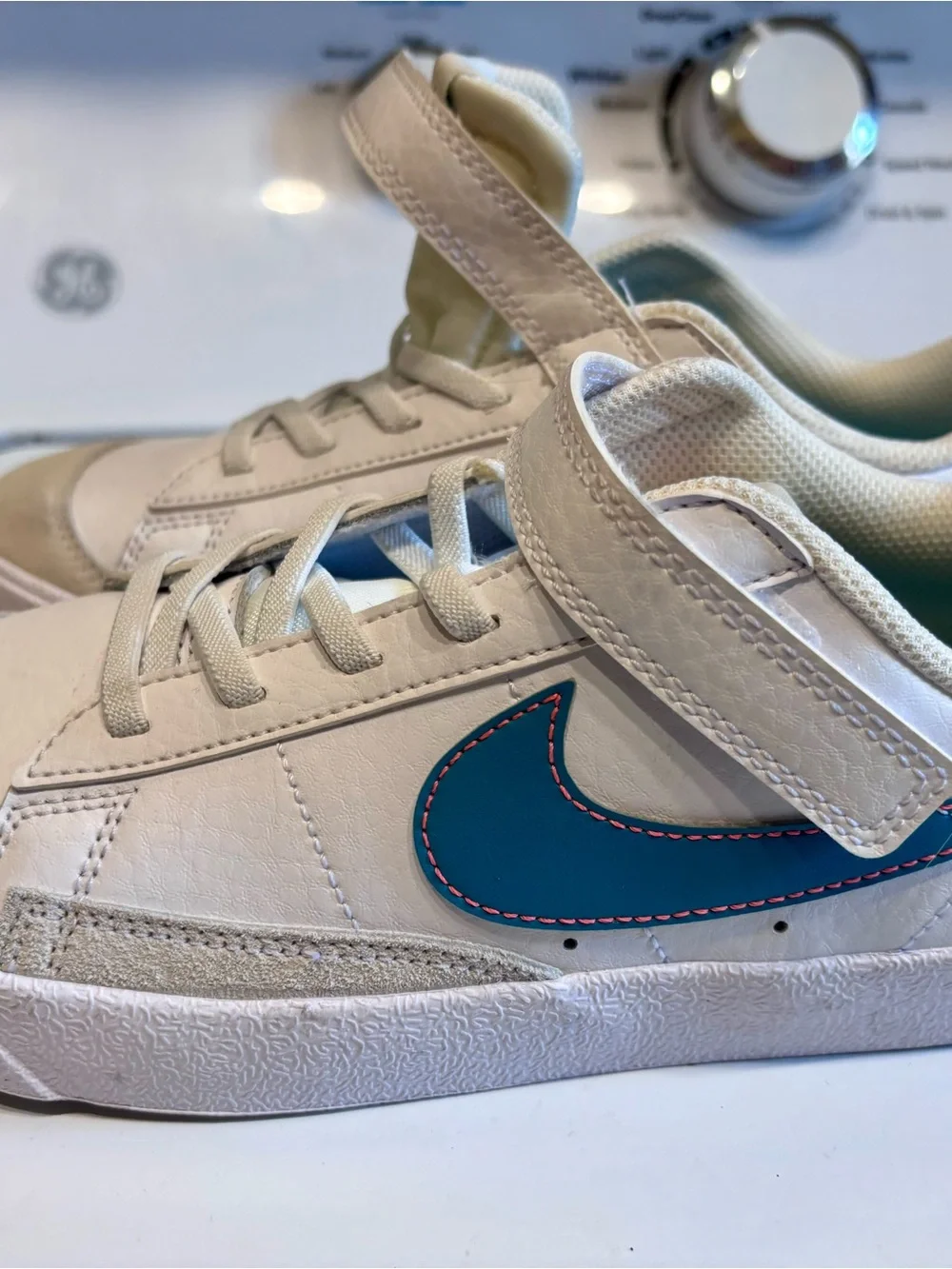 Nike Kids White Sneakers with Blue Swoosh and Pink Stitching